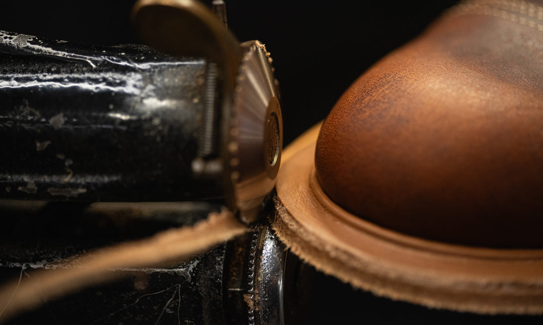 a close up shot of 5-in-1 machine trimming midsole and welt leather