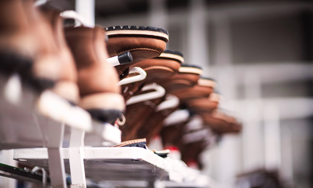 upside down brown moc toe boots on production racks