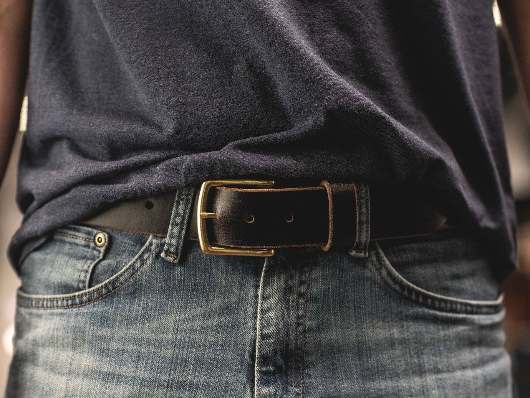 man wearing dark brown leather belt close shot wearing denim