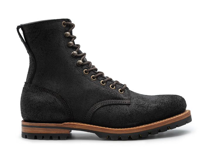 black rough out leather boot on a white background side view