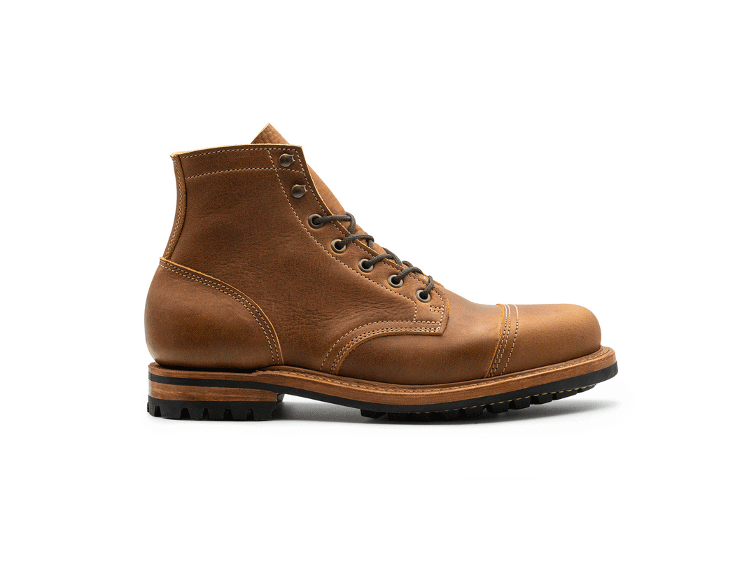 rotating 360° view of tan brown leather cap toe boot on white background