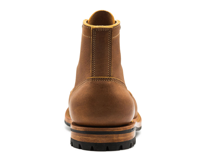 back view of tan brown leather cap toe boot on white background