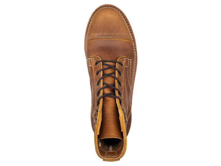topdown view of tan brown leather cap toe boot on white background