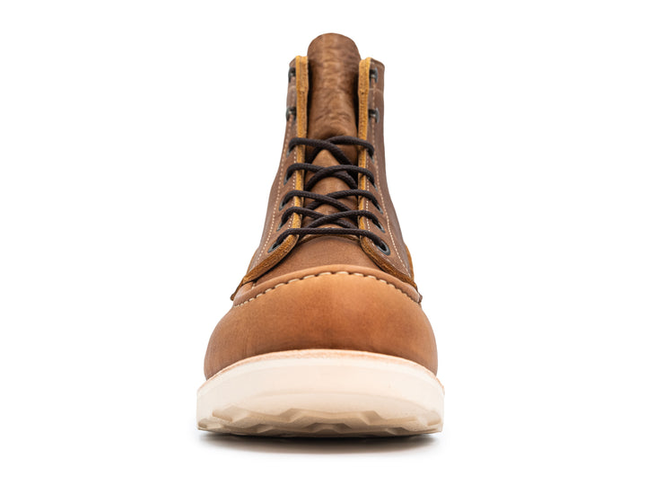 front view of light brown leather moc toe boot on white background