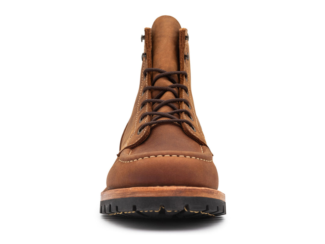 front view of brown leather moc toe boot on white background