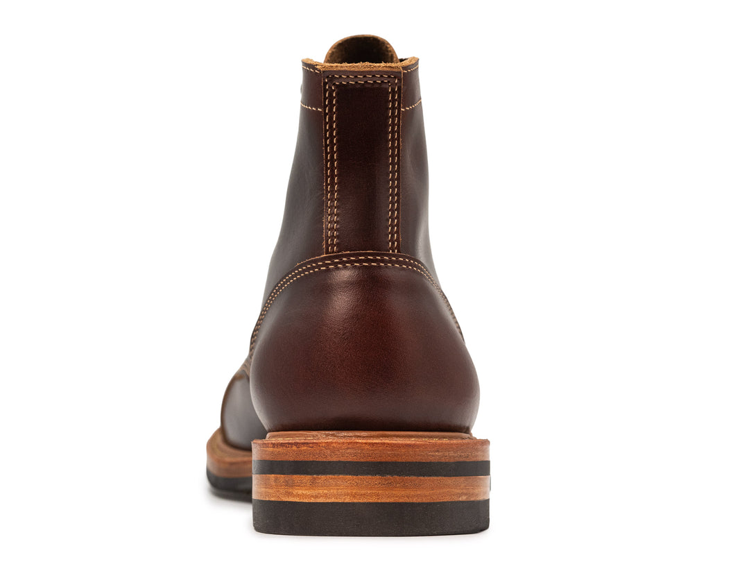 brown leather boot on white background back view