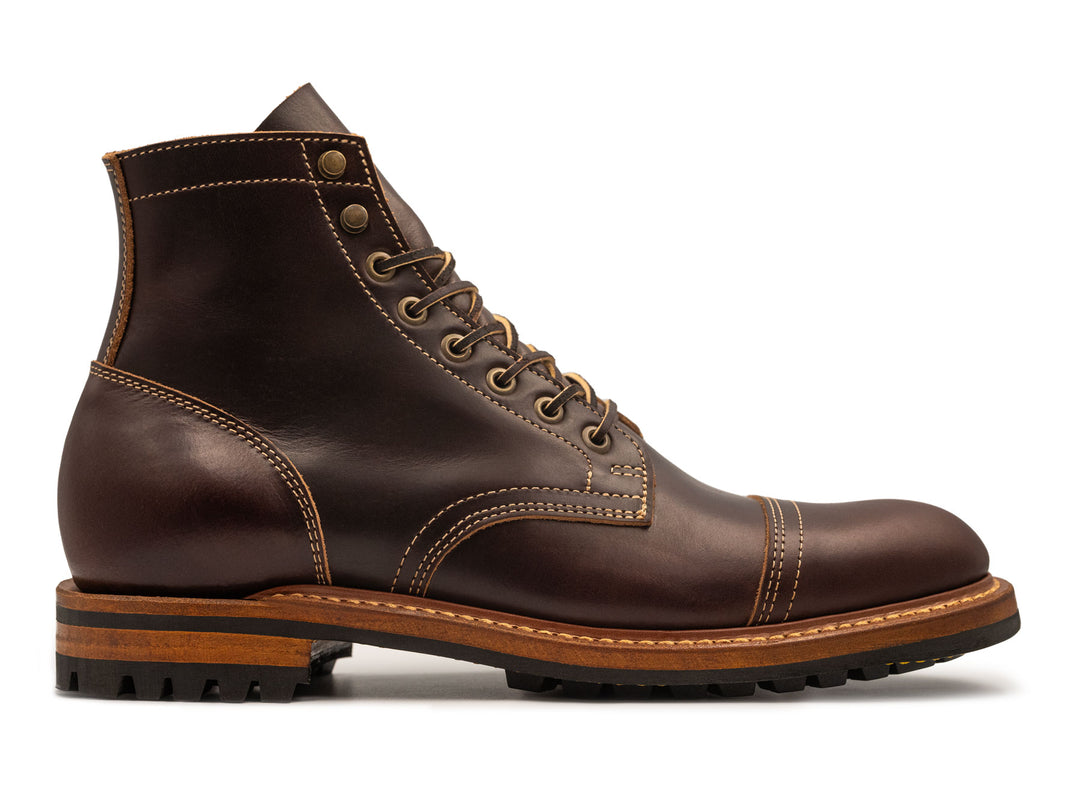 Brown leather boot with a white background