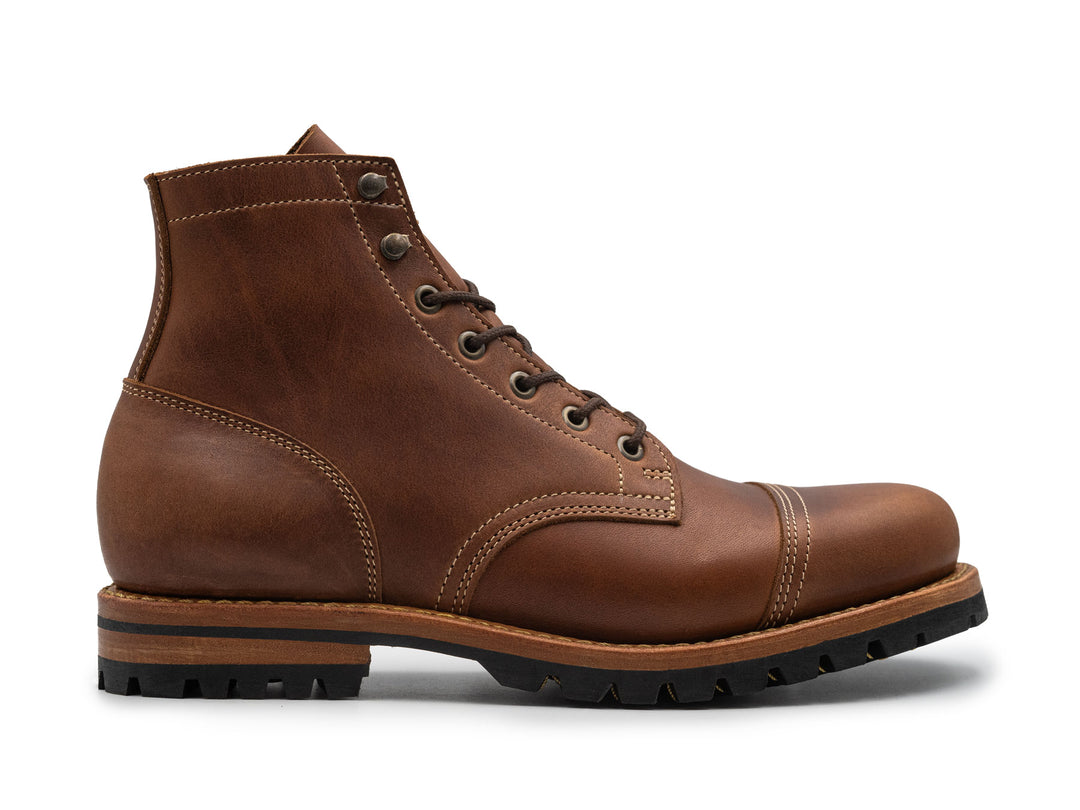 Brown leather boot on a white background side view