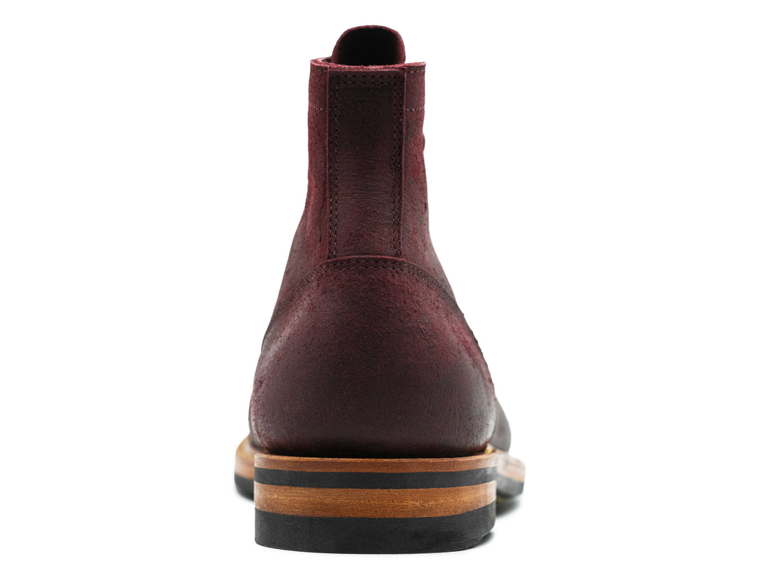 back view of dark burgundy leather boot on white background