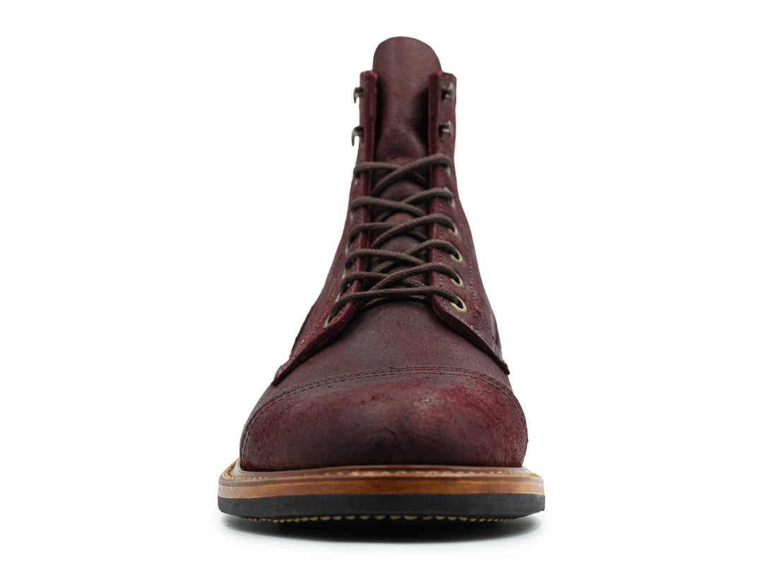 front view of dark burgundy leather boot on white background