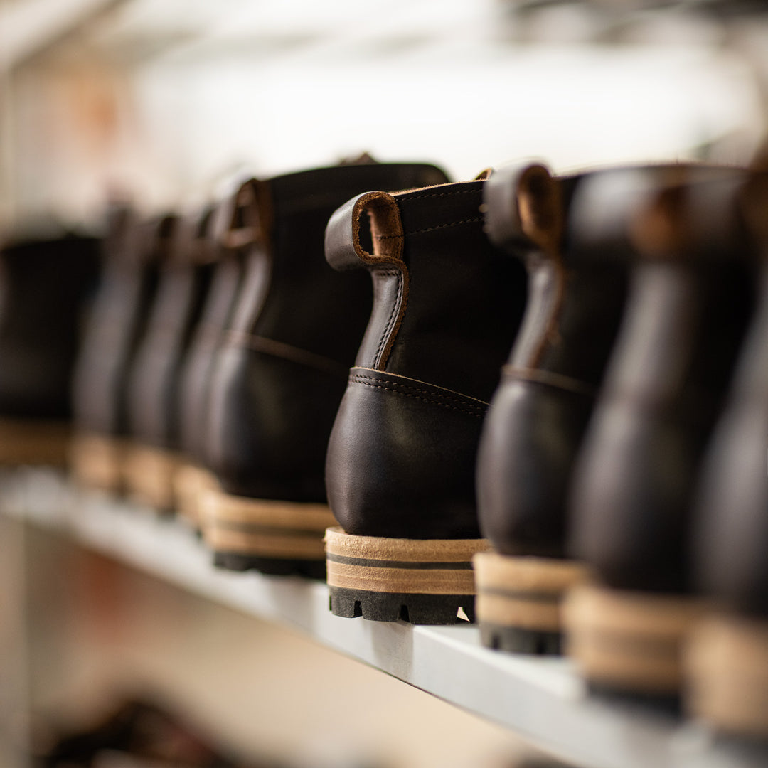unfinished black leather boots on rack 