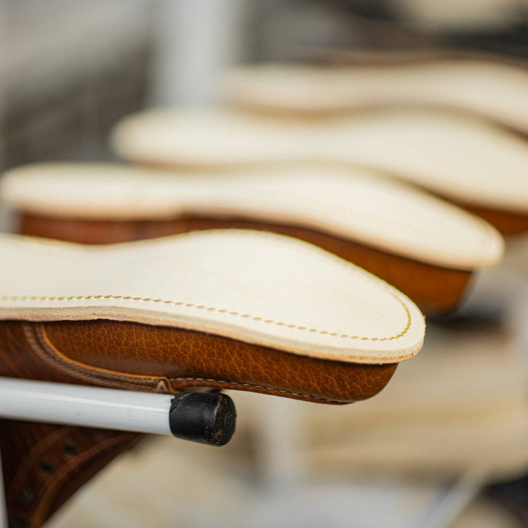 cognac shrunken bison moc toe boots in production upside down after midsole stitching