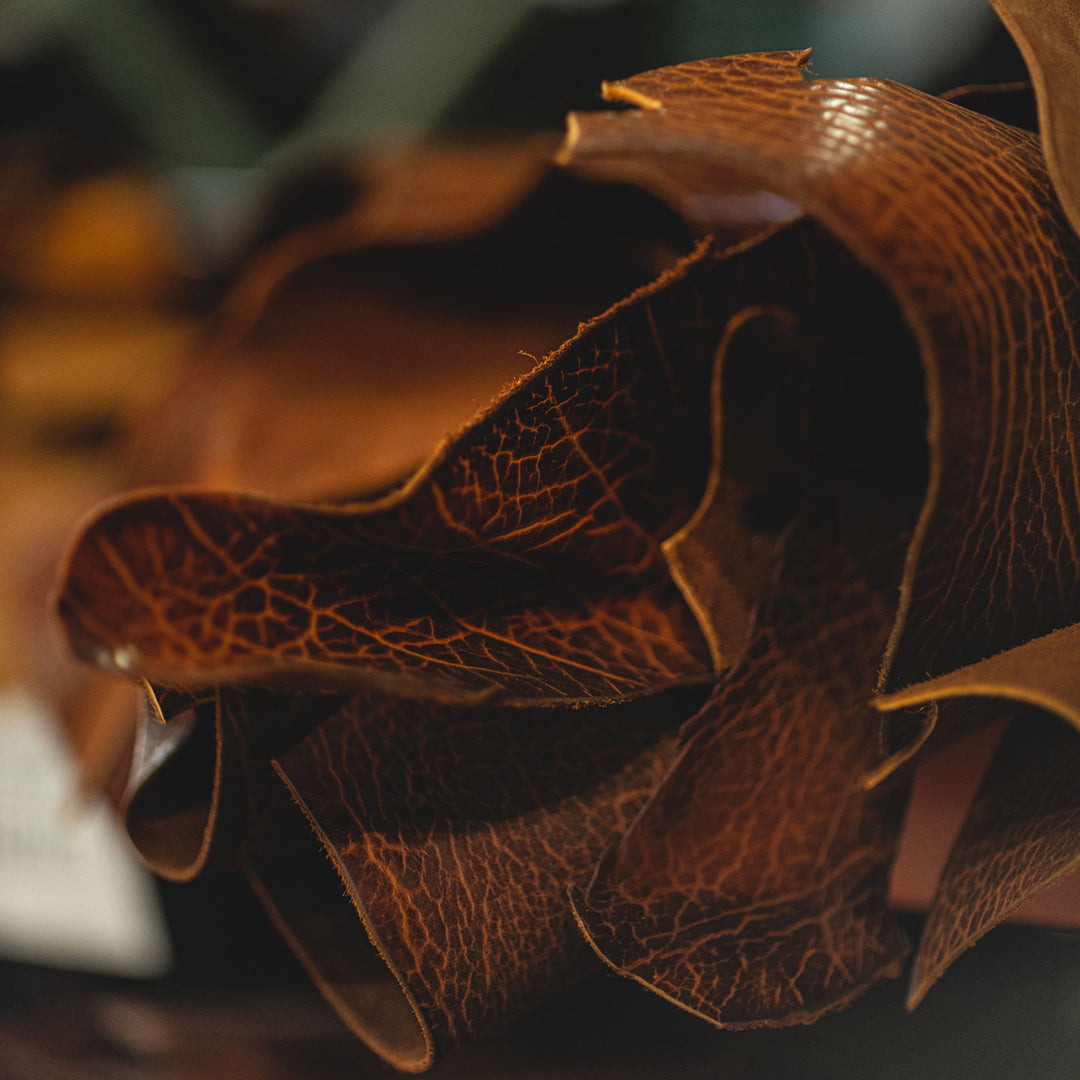 close up of cognac shrunken bison leather rolls