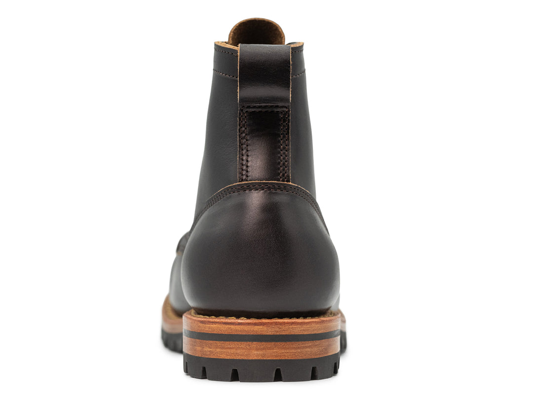 rear view of black moc toe boot on white background
