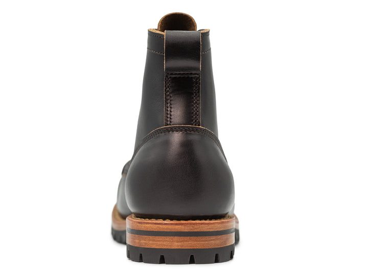 rear view of black moc toe boot on white background