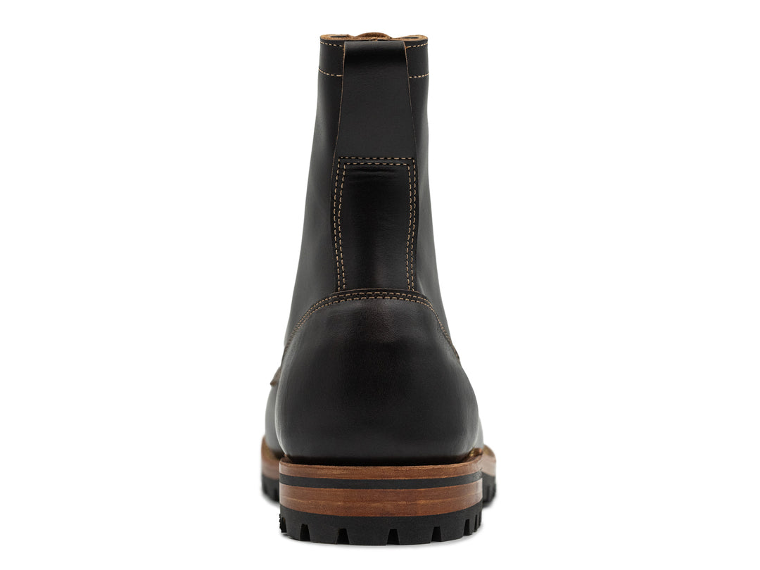 rear view of tall black leather boot on white background