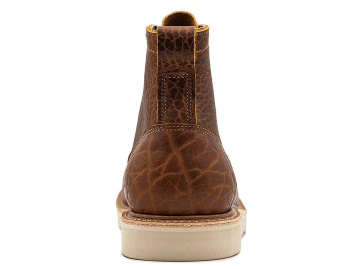 back view of cognac shrunken bison moc toe boot on white background