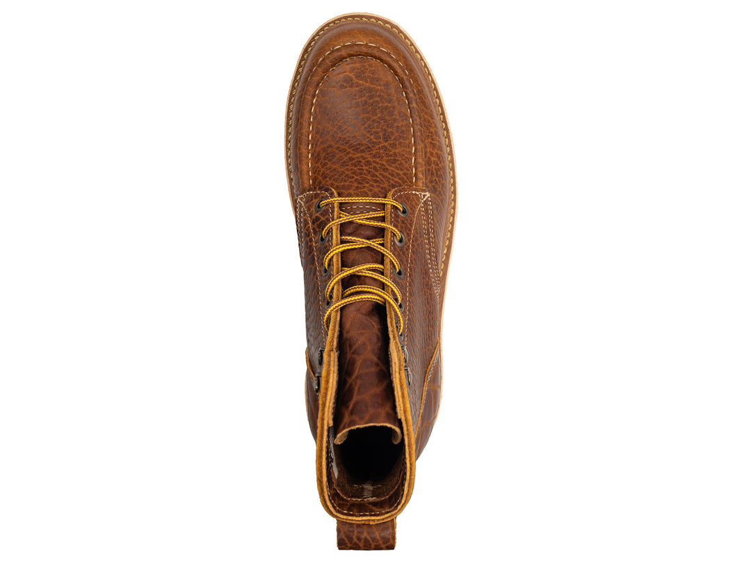 topdown view of cognac shrunken bison moc toe boot on white background