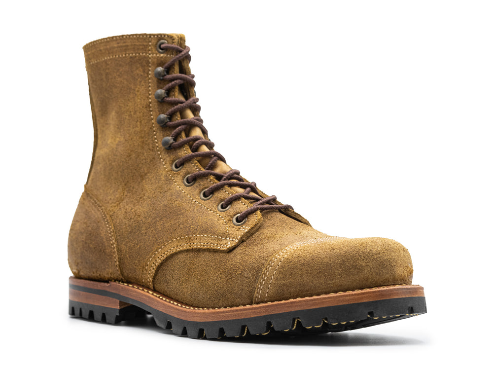 three-quarter view of coyote oiled rough out leather boot on white background