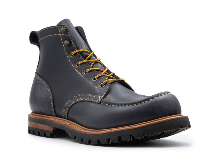 three-quarter view of steel blue leather boot on white background