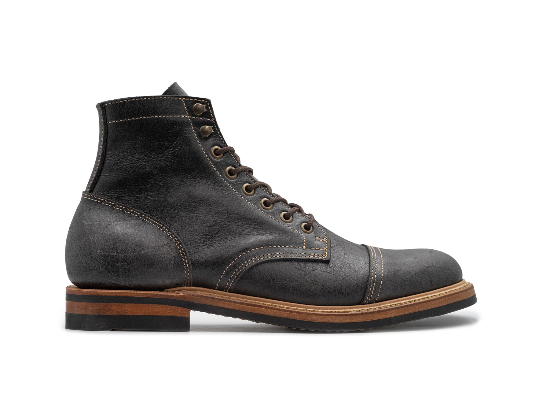side view of gray textured leather boot on white background
