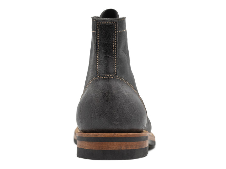 back view of gray textured leather boot on white background