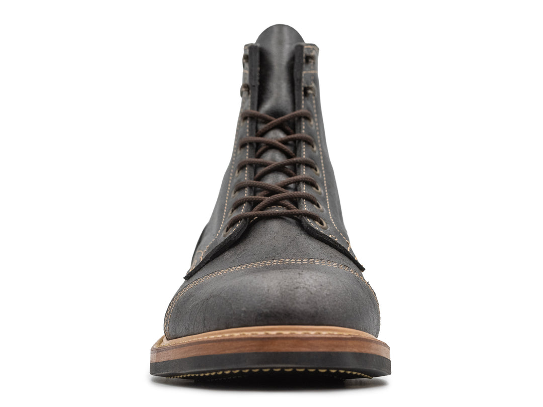 front view of gray textured leather boot on white background