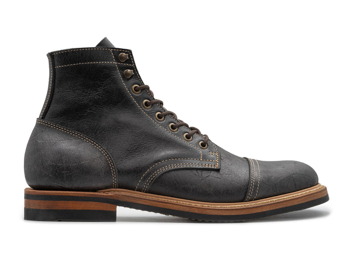 textured gray leather boot on white background