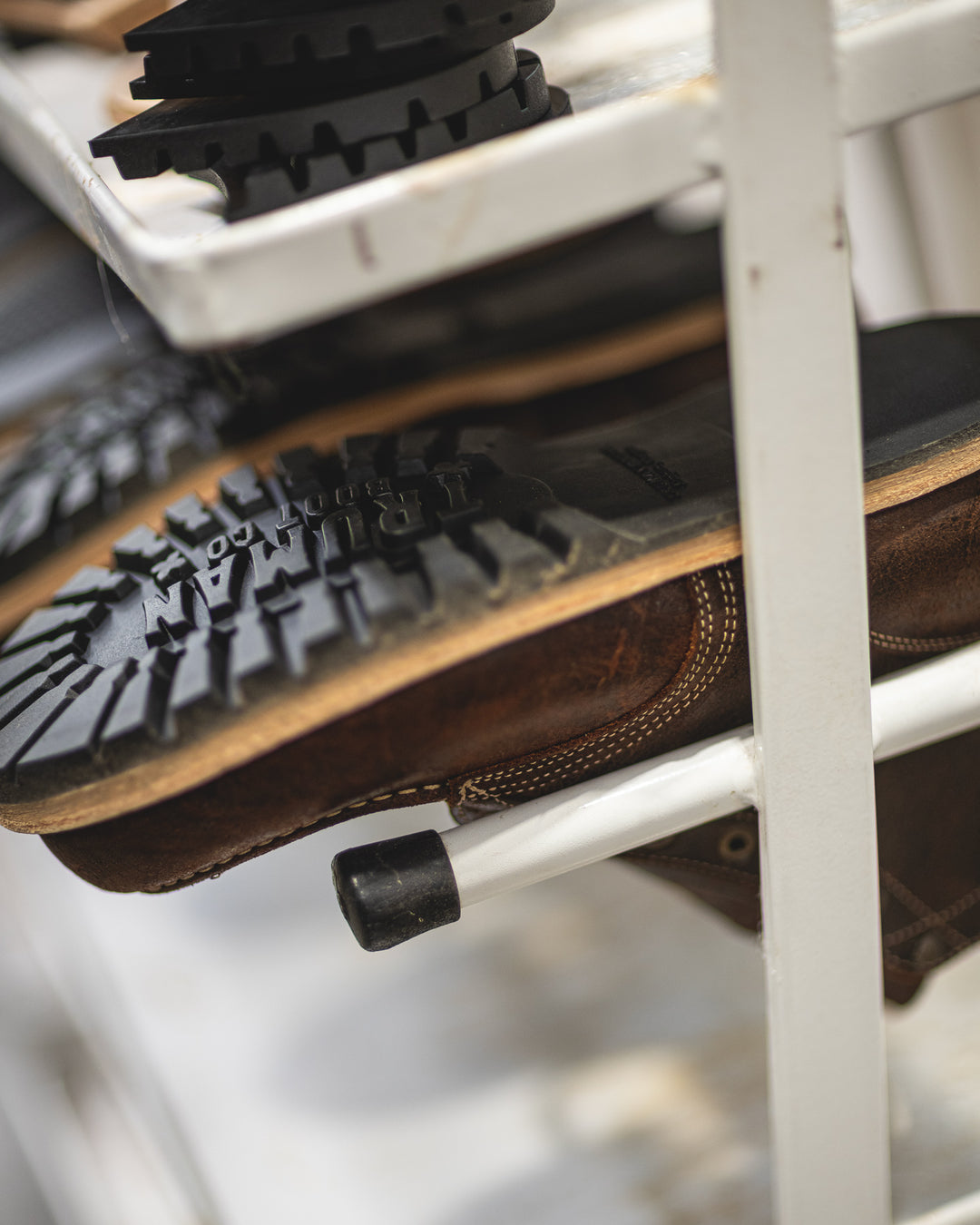 topdown view of sole on brown leather moc toe boots in production