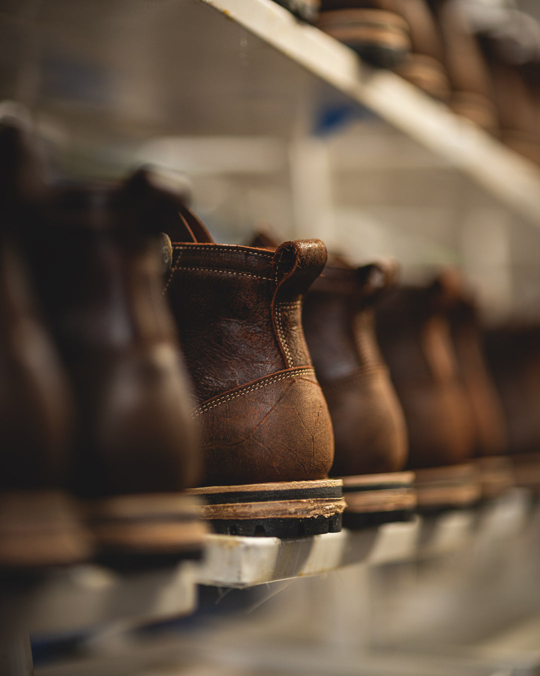 textured brown leather boots unfinished in production from back