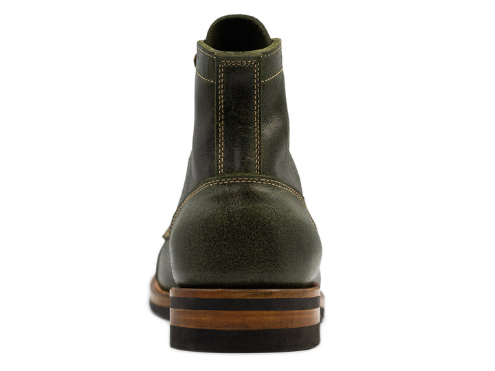 rear view of a textured green leather boot on white background