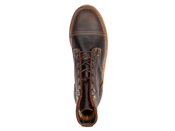 topdown view of brown textured leather boot on white background
