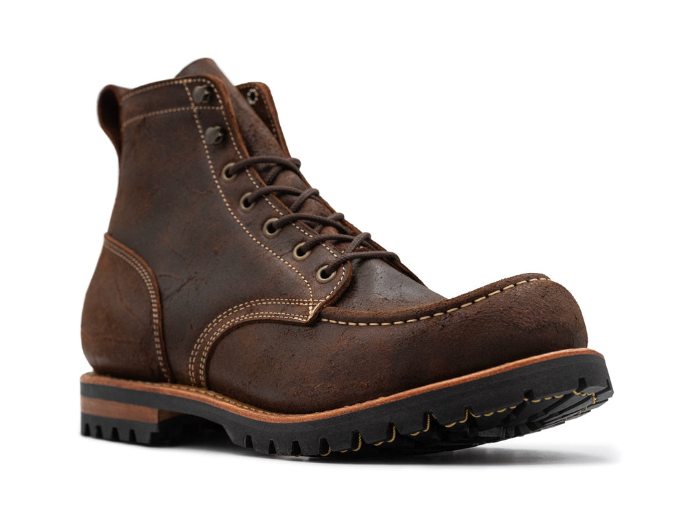 3qtr view of textured brown leather moc toe boots on white background