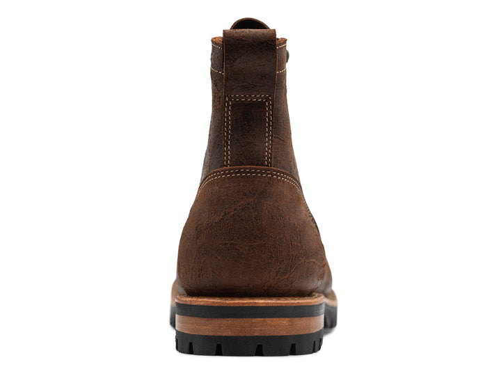 back view of textured brown leather moc toe boots on white background