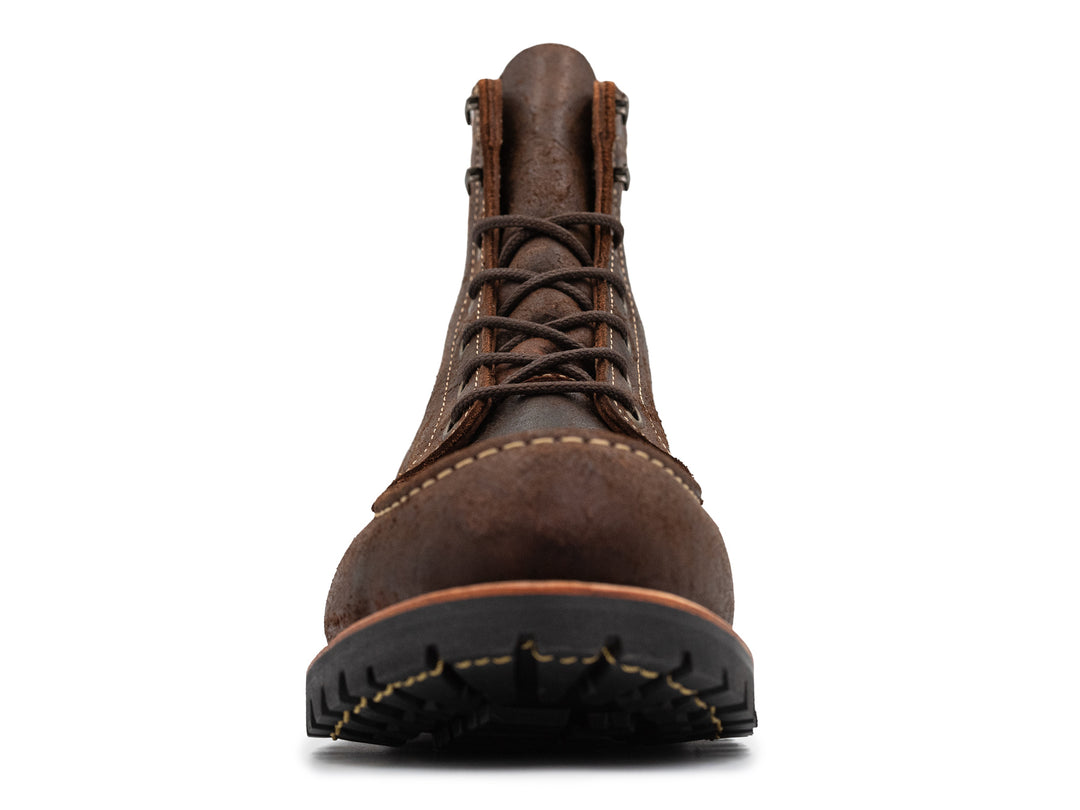 front view of textured brown leather moc toe boots on white background