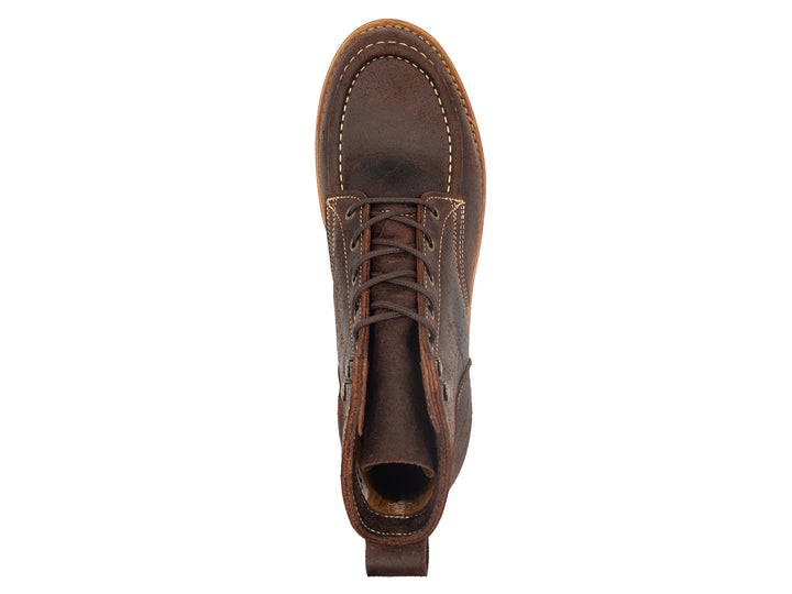 topdown view of textured brown leather moc toe boots on white background