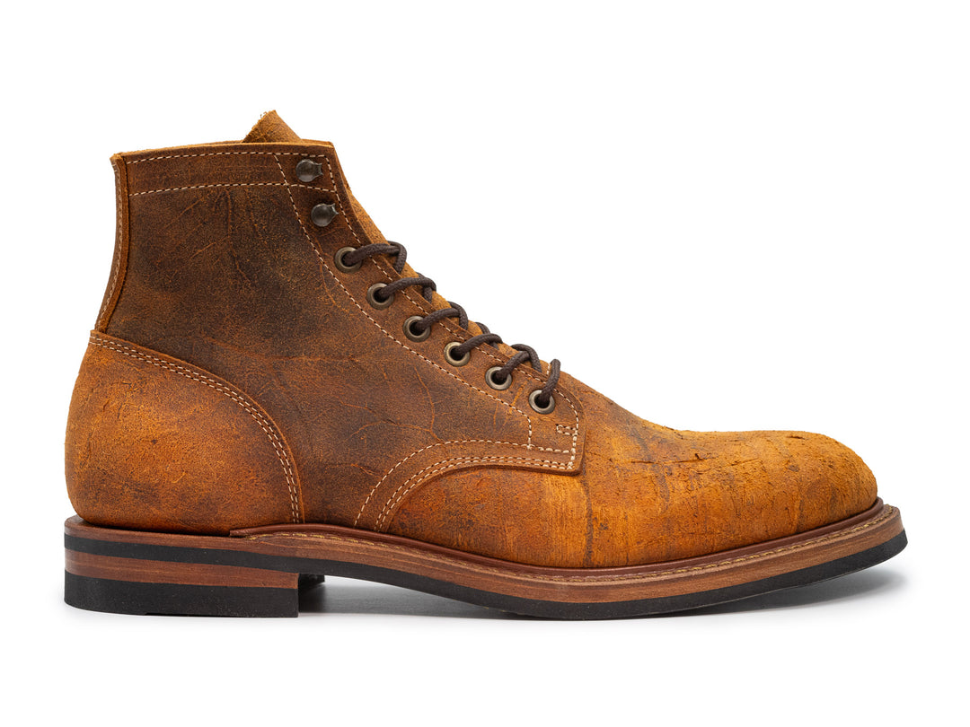 orange textured leather boot on white background
