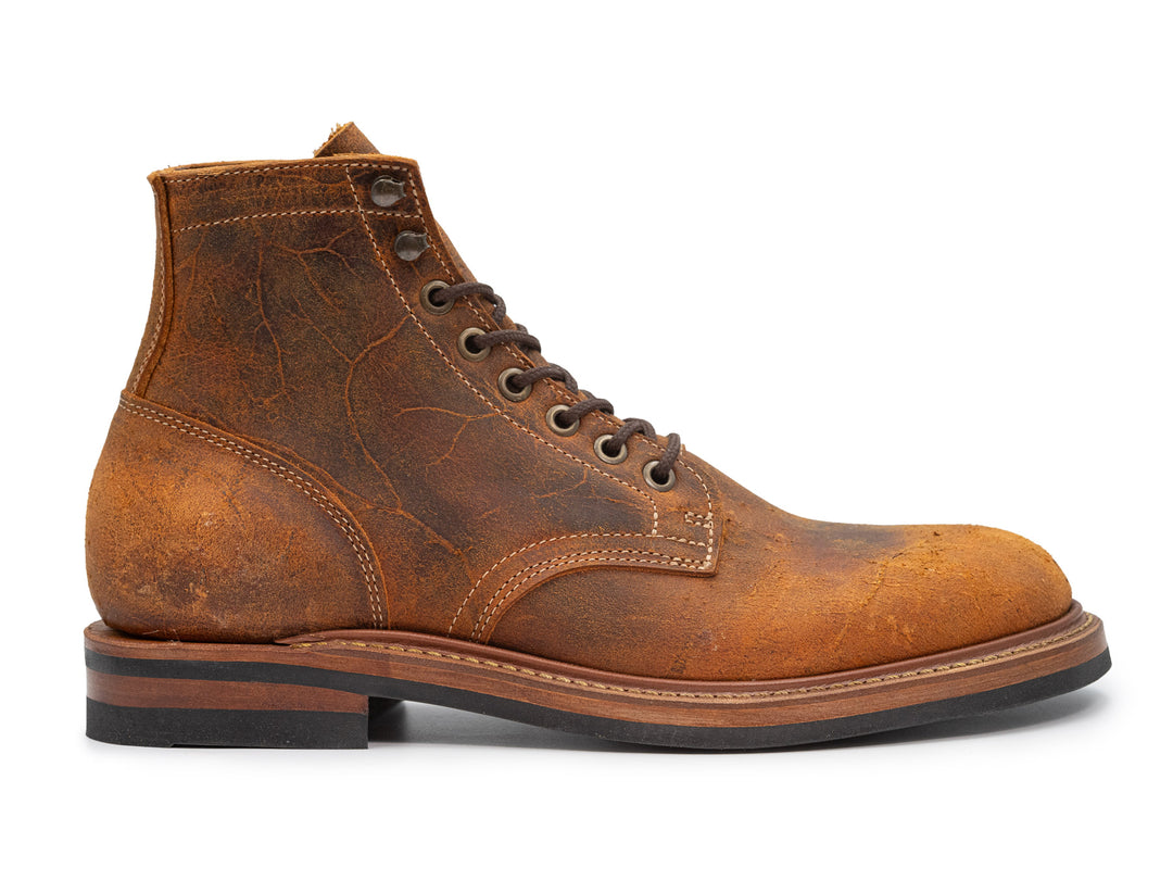 orange textured leather boot on white background