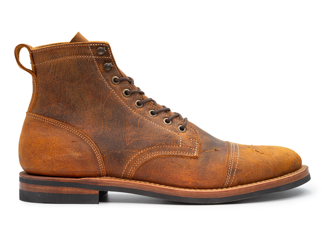orange textured leather boot on white background
