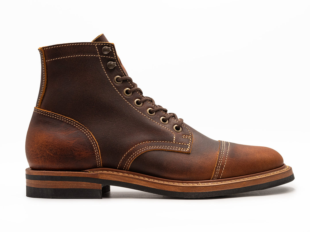 rich brown leather boot on white background