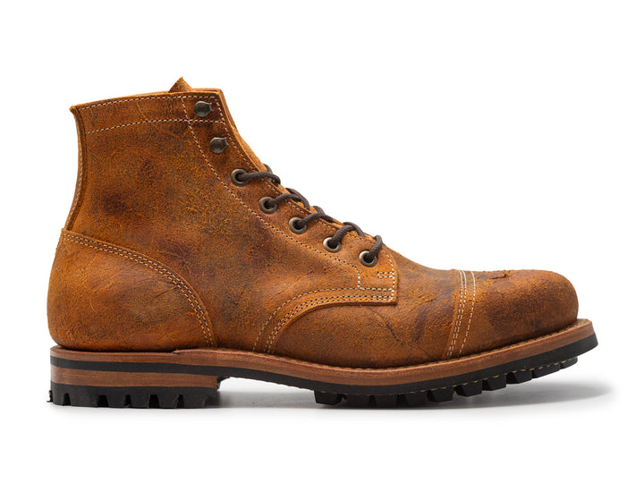 orange tan brown leather boot on white background