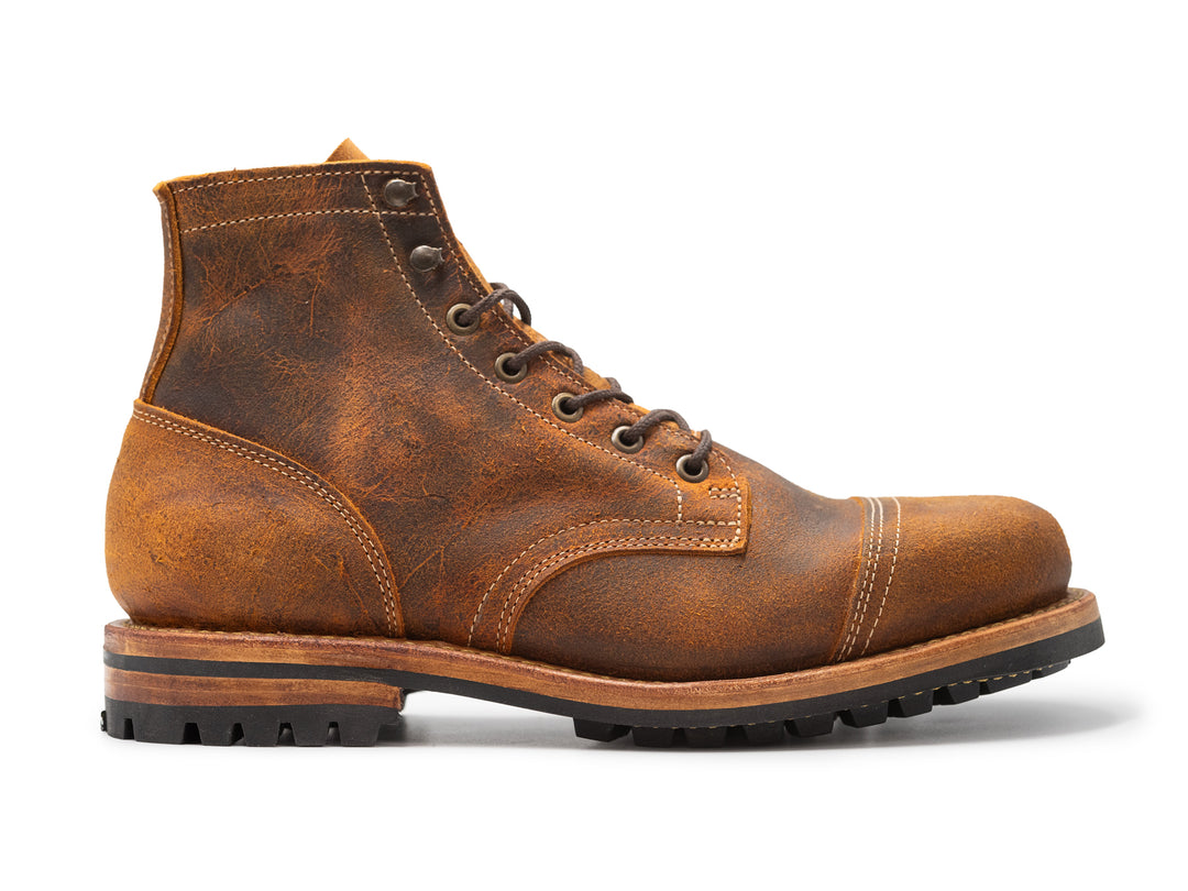 orange tan brown leather boot on white background