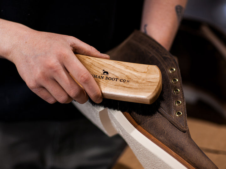 Horsehair brush in use cleaning boot